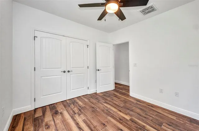a kitchen with wooden floor and window