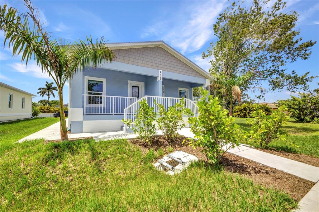 409 Carmalita Street, Unit 111 & 112 Punta Gorda, FL 33950 - Photo 2 of 75 a house that has a tree in front of it