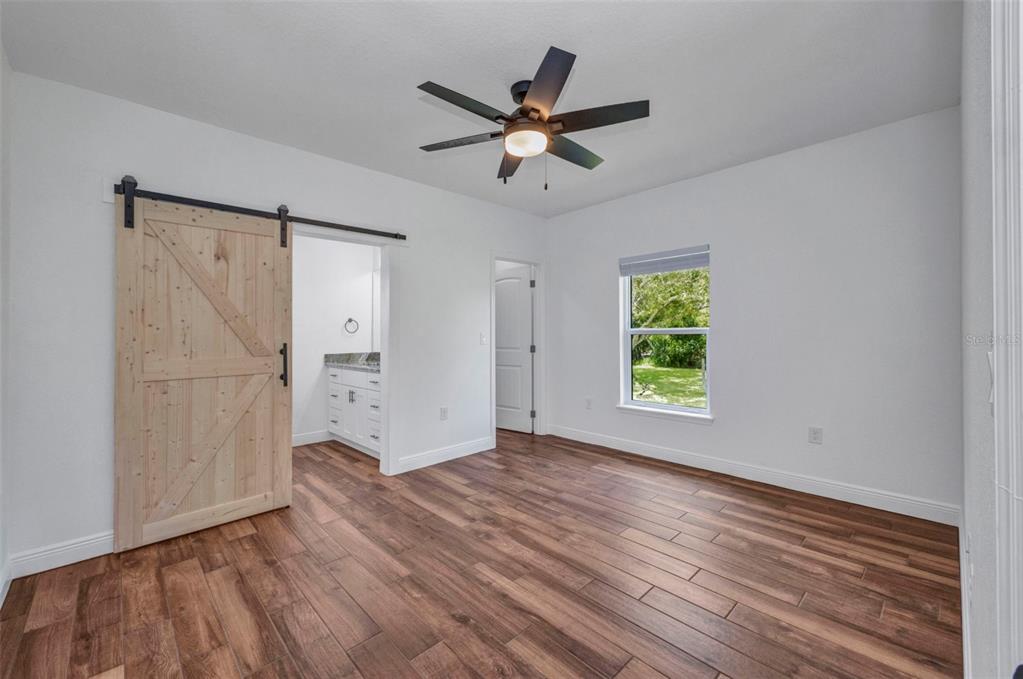409 Carmalita Street, Unit 111 & 112 Punta Gorda, FL 33950 - Photo 21 of 75 wooden floor in an empty room with a window