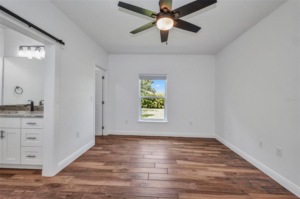 409 Carmalita Street, Unit 111 & 112 Punta Gorda, FL 33950 - Photo 22 of 75 wooden floor in an empty room with a window