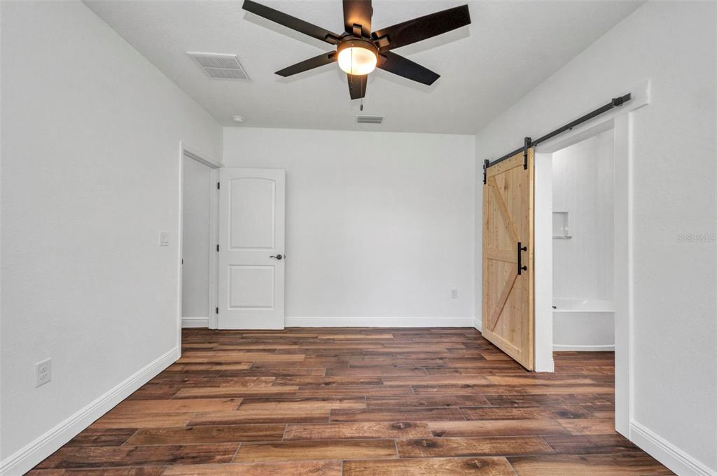 409 Carmalita Street, Unit 111 & 112 Punta Gorda, FL 33950 - Photo 23 of 75 a view of empty room with wooden floor and fan