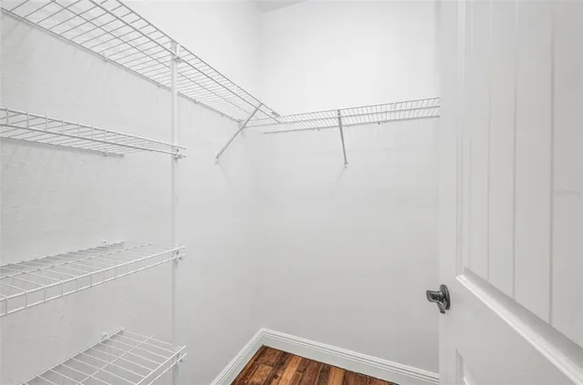 a kitchen with granite countertop stainless steel appliances and white cabinets