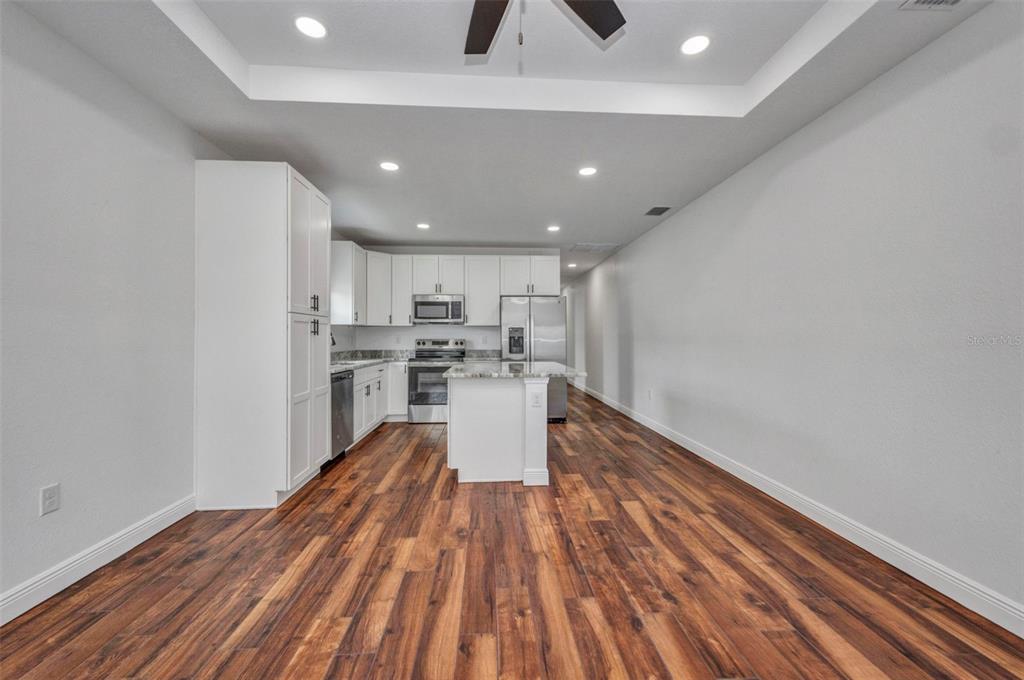 409 Carmalita Street, Unit 111 & 112 Punta Gorda, FL 33950 - Photo 32 of 75 a kitchen with wooden floor and window