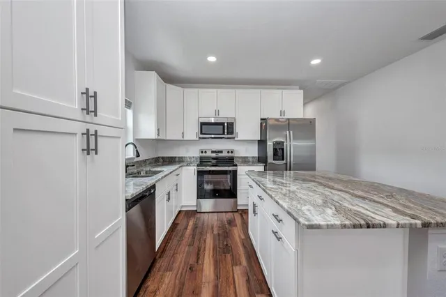 a white toilet sitting next to a bath tub
