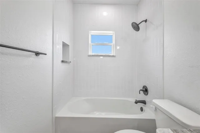 an aerial view of residential houses with outdoor space and swimming pool