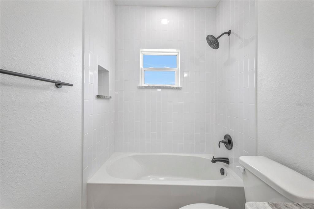 409 Carmalita Street, Unit 111 & 112 Punta Gorda, FL 33950 - Photo 42 of 75 a bathroom with a bathtub