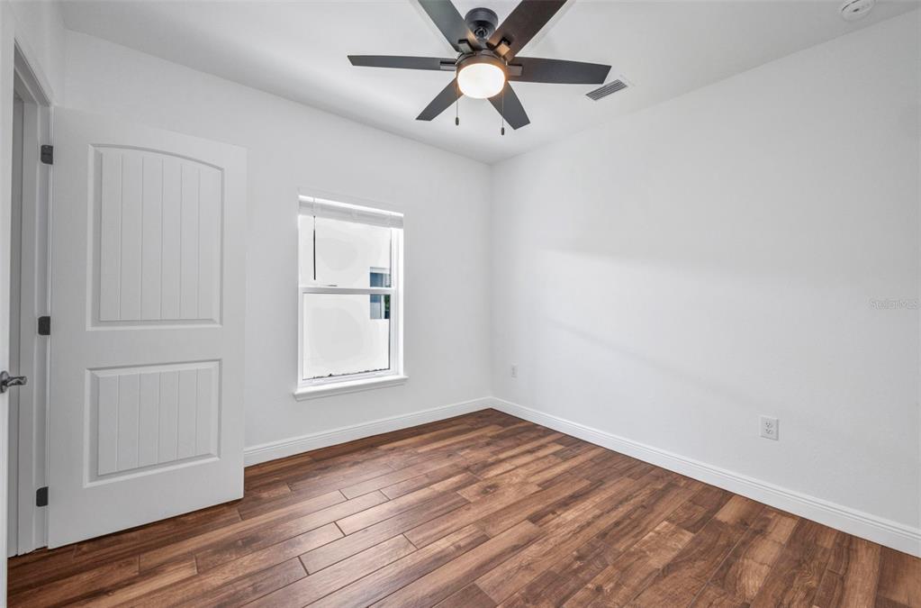 409 Carmalita Street, Unit 111 & 112 Punta Gorda, FL 33950 - Photo 45 of 75 wooden floor in an empty room with a window