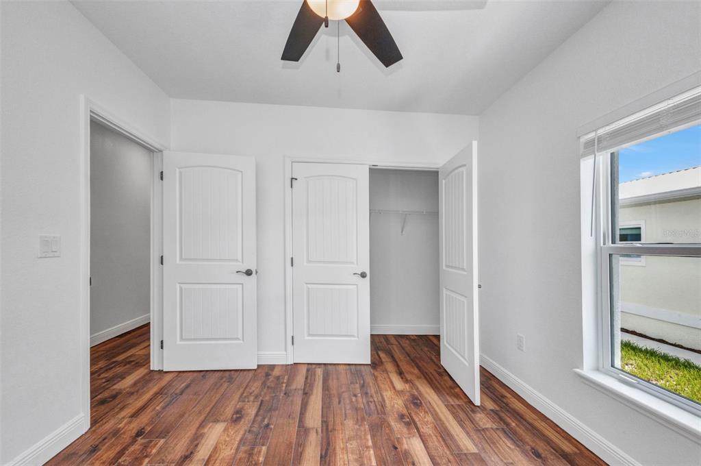 409 Carmalita Street, Unit 111 & 112 Punta Gorda, FL 33950 - Photo 47 of 75 a view of empty room with wooden floor and window