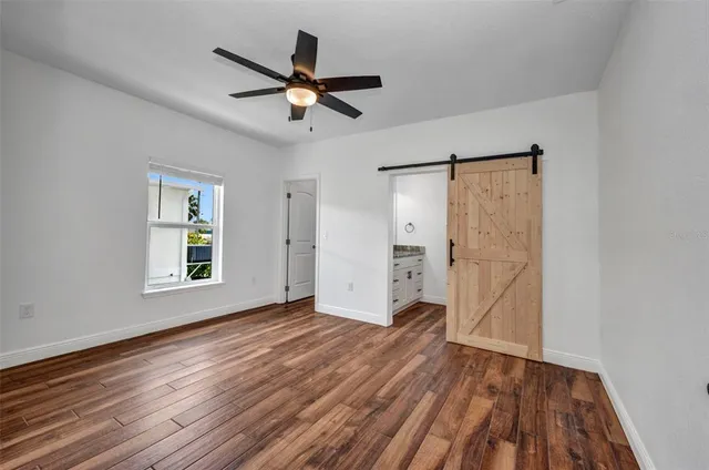 an aerial view of a residential houses with outdoor space and a lake view