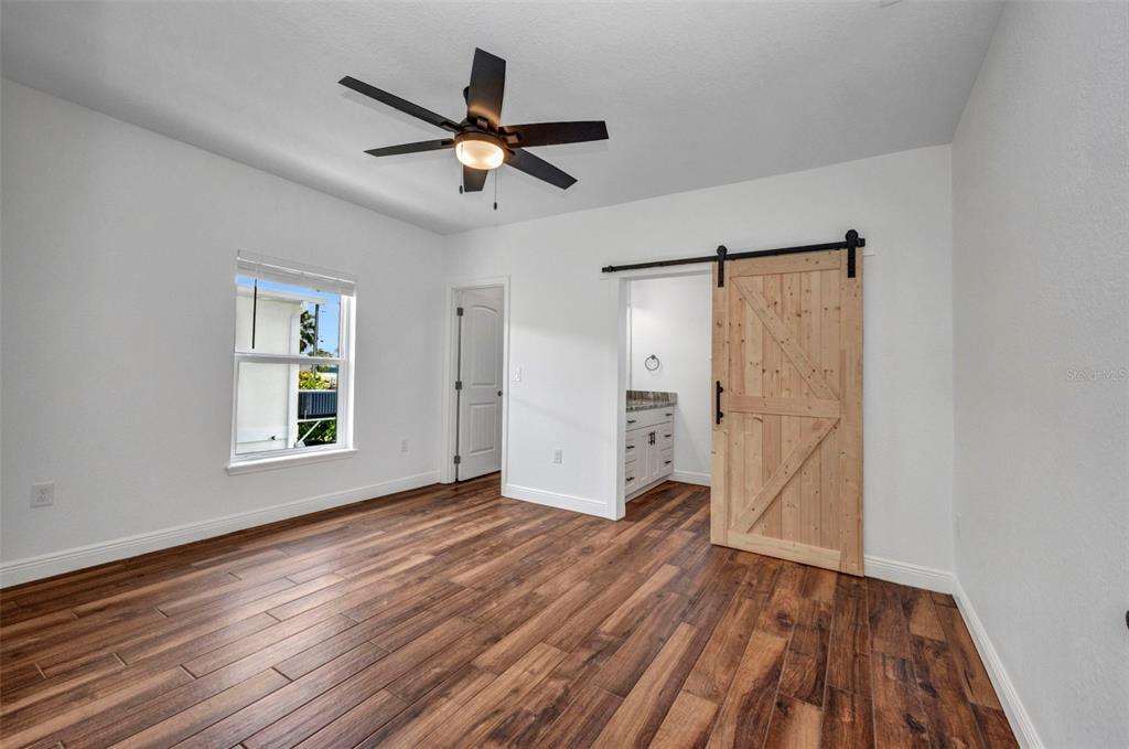 409 Carmalita Street, Unit 111 & 112 Punta Gorda, FL 33950 - Photo 48 of 75 a view of an empty room with wooden floor and a window