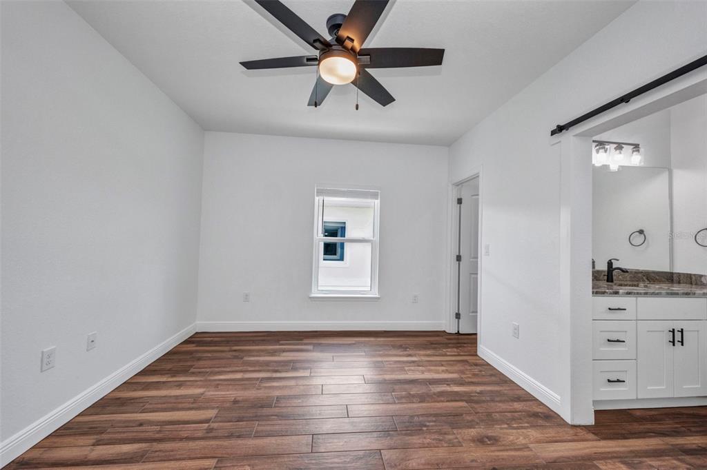 409 Carmalita Street, Unit 111 & 112 Punta Gorda, FL 33950 - Photo 49 of 75 wooden floor in an empty room with a window