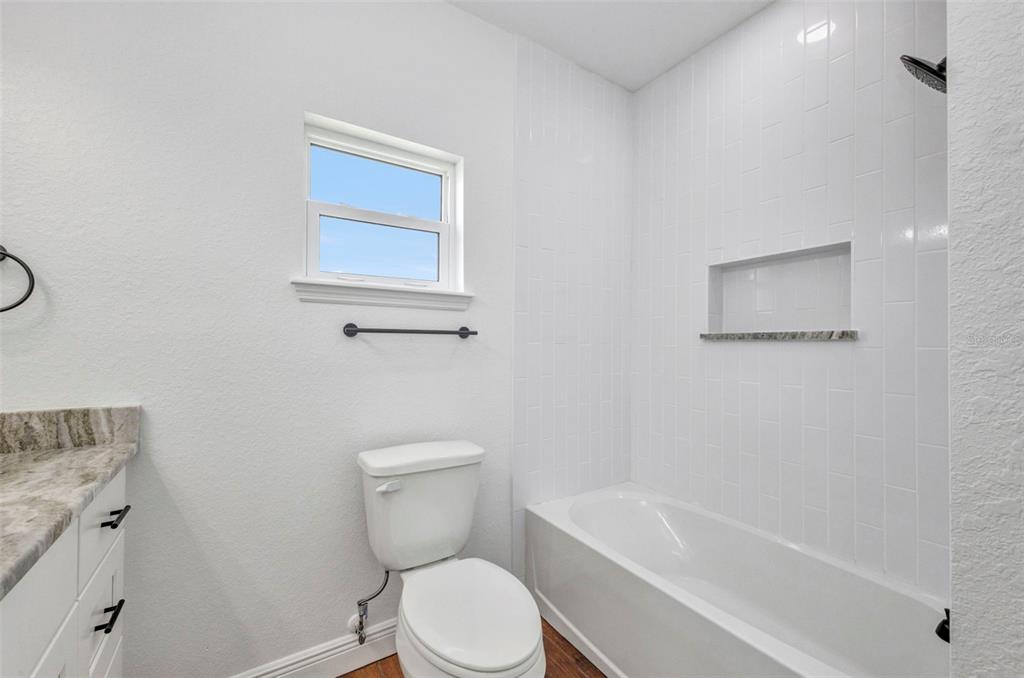 409 Carmalita Street, Unit 111 & 112 Punta Gorda, FL 33950 - Photo 52 of 75 a white toilet sitting next to a bath tub