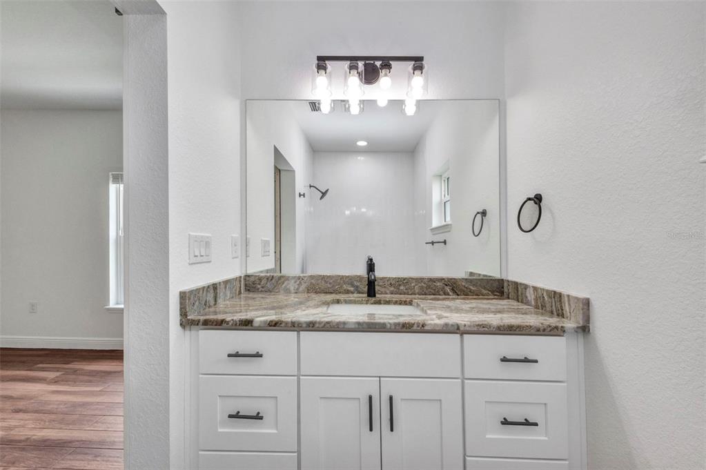 409 Carmalita Street, Unit 111 & 112 Punta Gorda, FL 33950 - Photo 56 of 75 a bathroom with a sink and a mirror