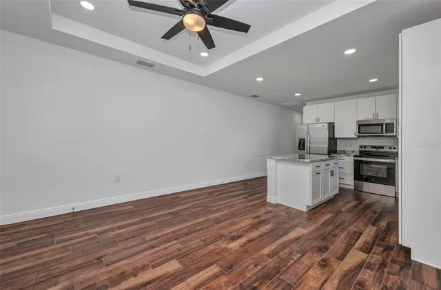 a bathroom with a granite countertop sink a toilet a mirror and shower