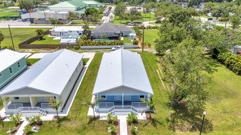 409 Carmalita Street, Unit 111 & 112 Punta Gorda, FL 33950 - Photo 74 of 75 a aerial view of a house with swimming pool and large trees