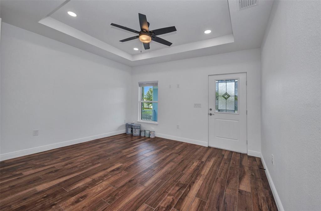 409 Carmalita Street, Unit 111 & 112 Punta Gorda, FL 33950 - Photo 9 of 75 wooden floor in an empty room with a window