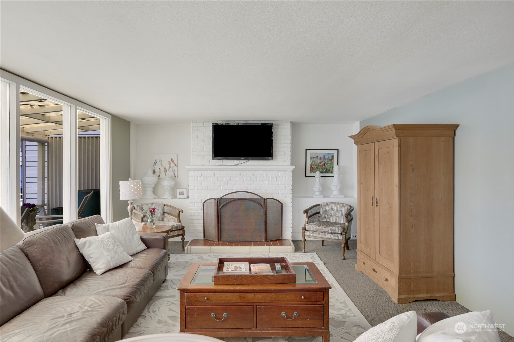 7005 Ripley Ln S East Renton, WA 98056 - Photo 19 of 35 a living room with furniture a fireplace and a flat screen tv