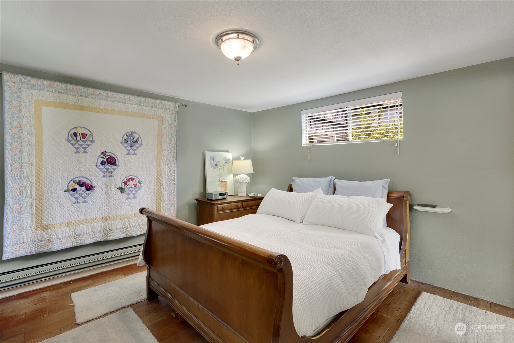 7005 Ripley Ln S East Renton, WA 98056 - Photo 23 of 35 a bedroom with bed and wall painting with wooden floor