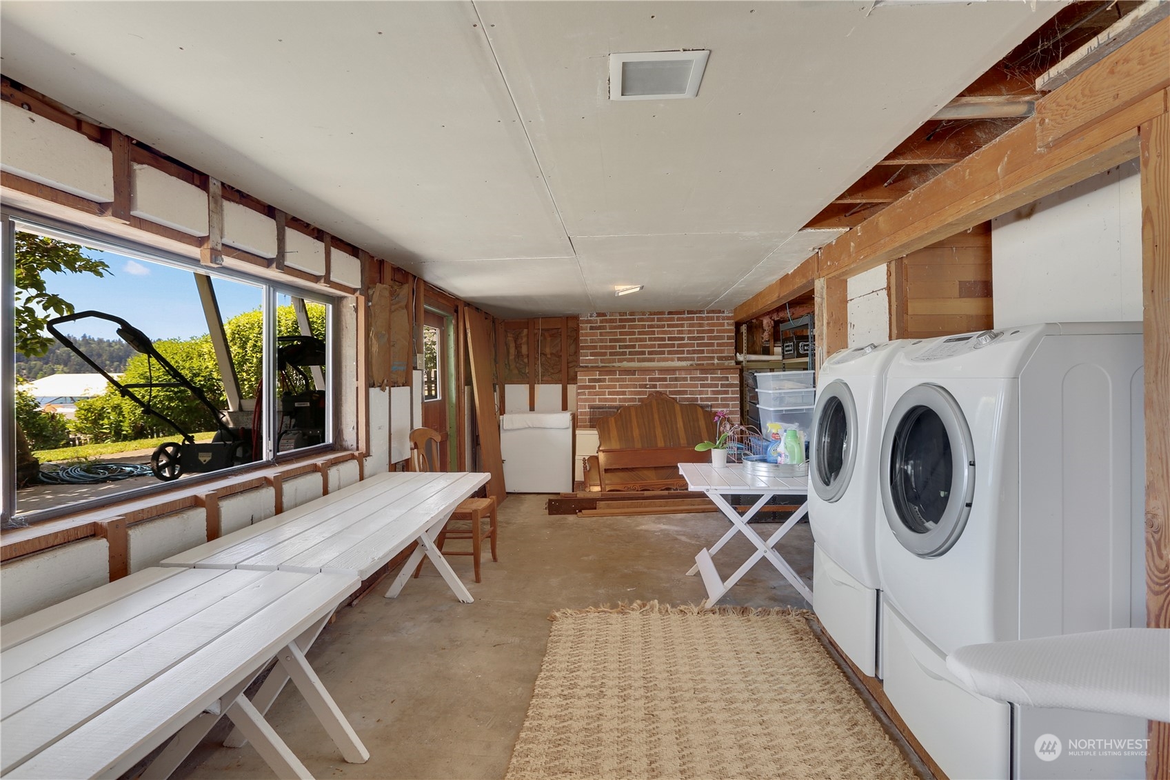 7005 Ripley Ln S East Renton, WA 98056 - Photo 26 of 35 a living room with furniture a flat screen tv and a floor to ceiling window