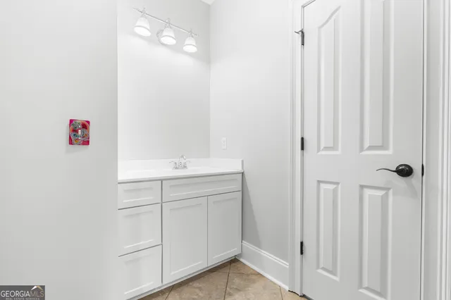 a bathroom with a sink vanity and a mirror