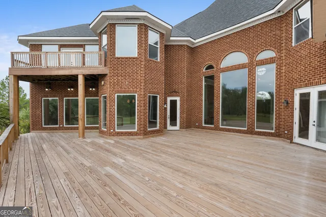 a view of a brick house with large windows