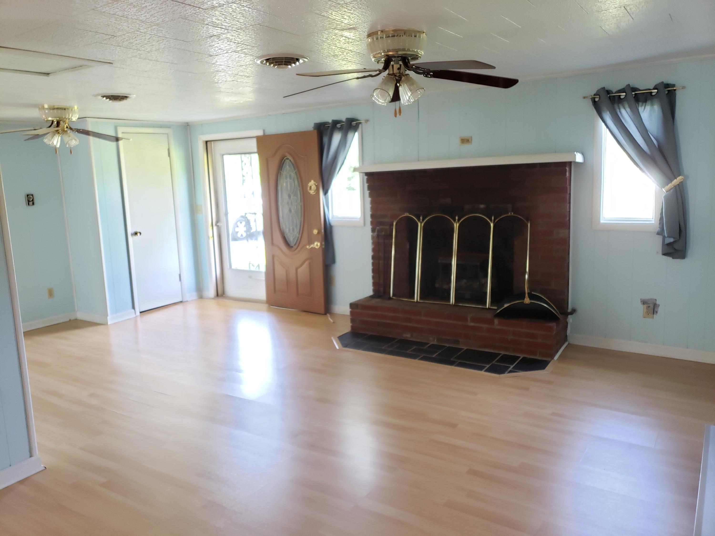 3529 Old Forge Road Rocky Mount, VA 24151 - Photo 3 of 14 a living room with a fireplace windows and wooden floor