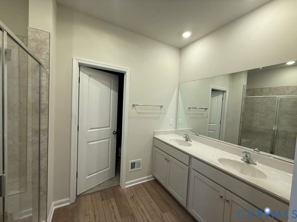 6473 Fennec Run Moseley, VA 23120 - Photo 6 of 16 Full bathroom featuring a shower stall, double van