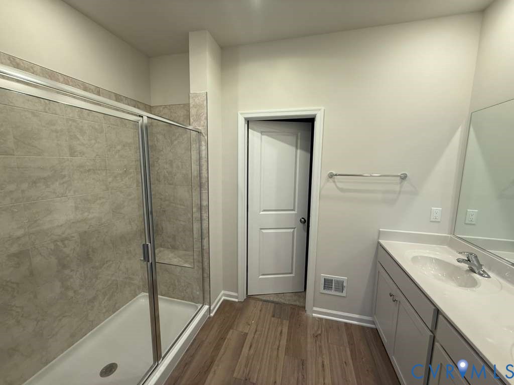 6473 Fennec Run Moseley, VA 23120 - Photo 7 of 16 Full bathroom with double vanity, a shower stall,
