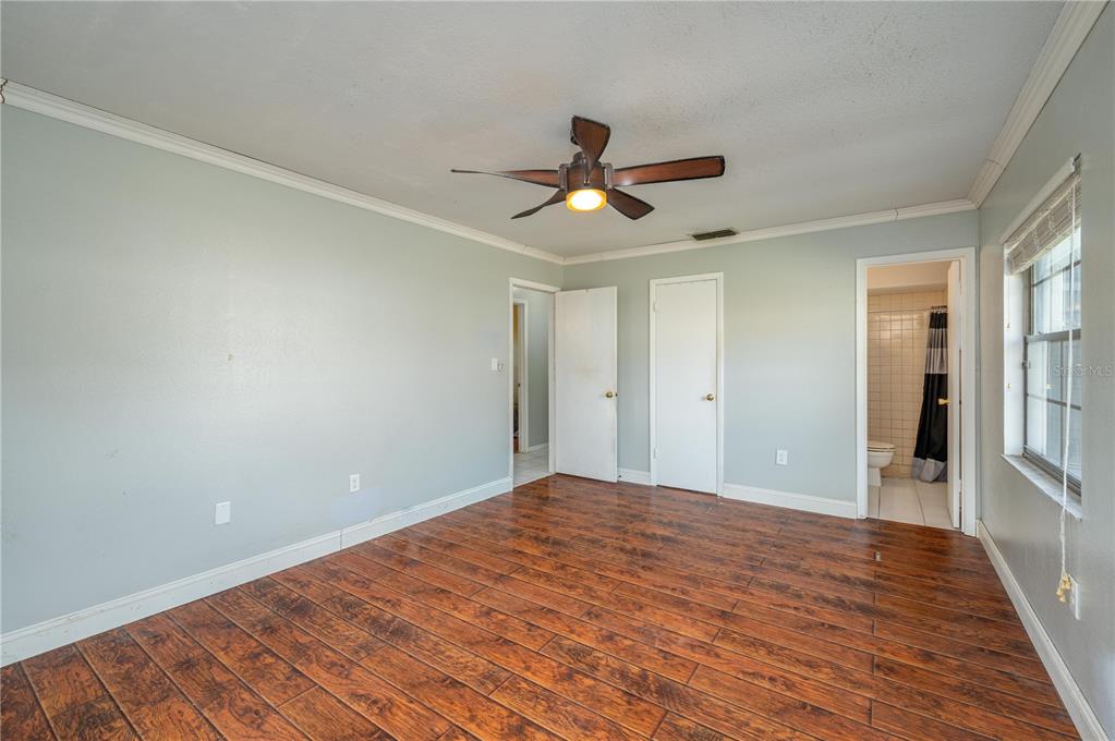 1330 Spring Court Bartow, FL 33830 - Photo 16 of 40 a view of a big room with wooden floor and a ceiling fan