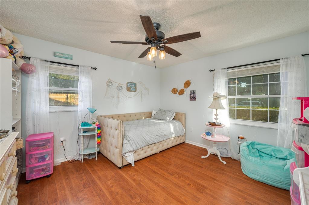 1330 Spring Court Bartow, FL 33830 - Photo 20 of 40 a bedroom with a bed and wooden floor