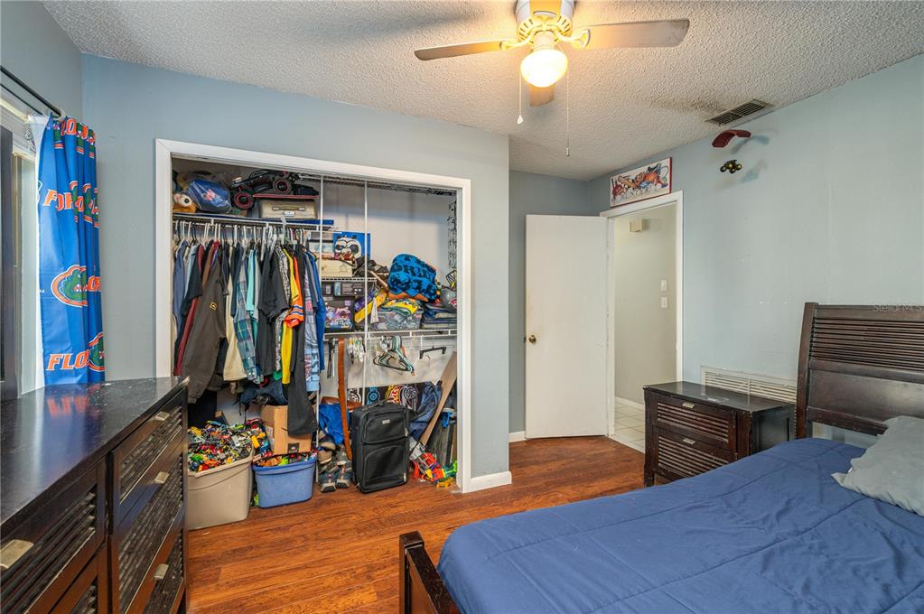 1330 Spring Court Bartow, FL 33830 - Photo 28 of 40 a bedroom with a bed and a chandelier