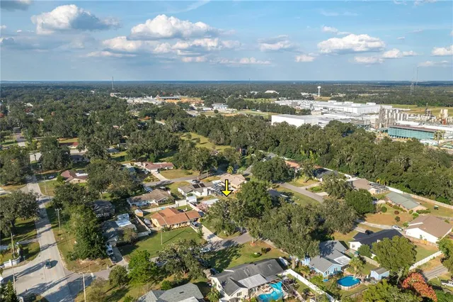 an aerial view of residential building with green space and street view