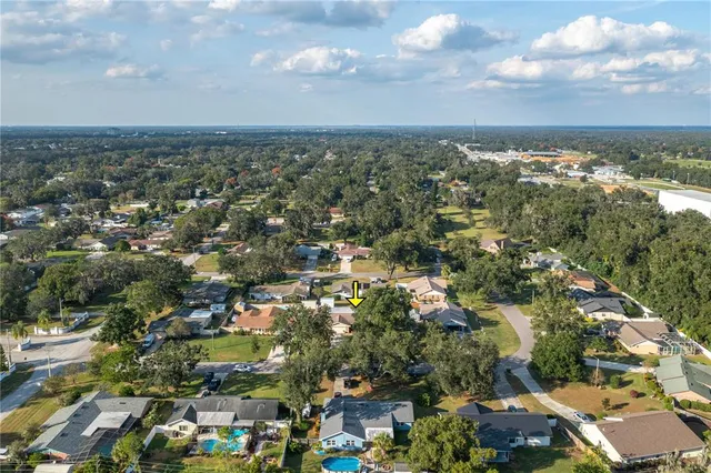 an aerial view of residential building with green space