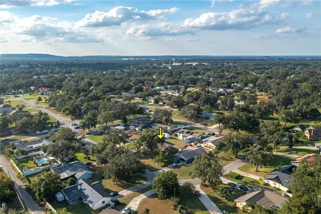 an aerial view of residential building with green space