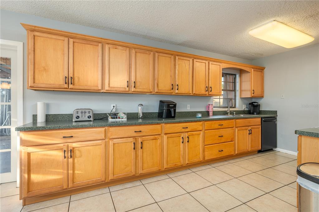 1330 Spring Court Bartow, FL 33830 - Photo 8 of 40 a kitchen with granite countertop cabinets stainless steel appliances a sink and a window
