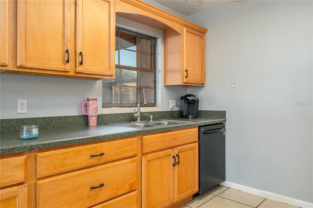 1330 Spring Court Bartow, FL 33830 - Photo 9 of 40 a kitchen with granite countertop cabinets sink and window