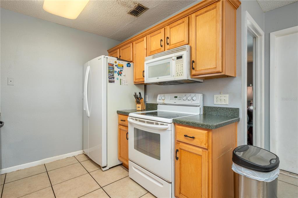 1330 Spring Court Bartow, FL 33830 - Photo 10 of 40 a kitchen with stainless steel appliances granite countertop a stove a washer and dryer