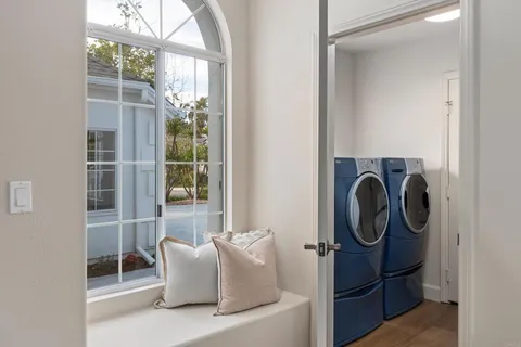 a dining room with wooden floor a chandelier a wooden table and chairs