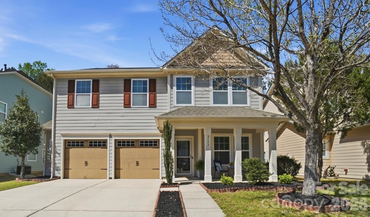 2153 Bluebell Way Tega Cay, SC 29708 - Photo 2 of 48 front view of a house with a garden