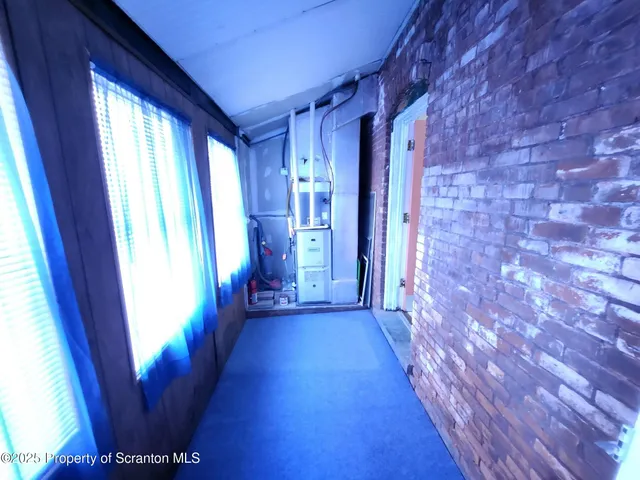 a view of a hallway with wooden floor and stairs