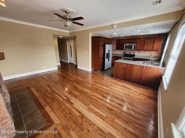a view of kitchen with cabinets and wooden floor