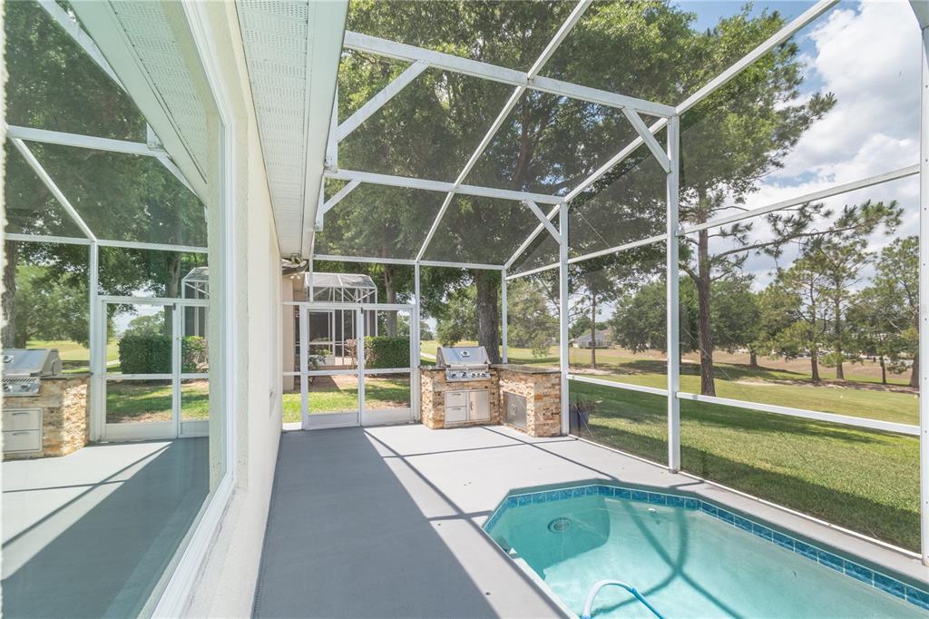 3862 Beacon Ridge Way Clermont, FL 34711 - Photo 45 of 56 a view of a swimming pool with a large window and wooden floor