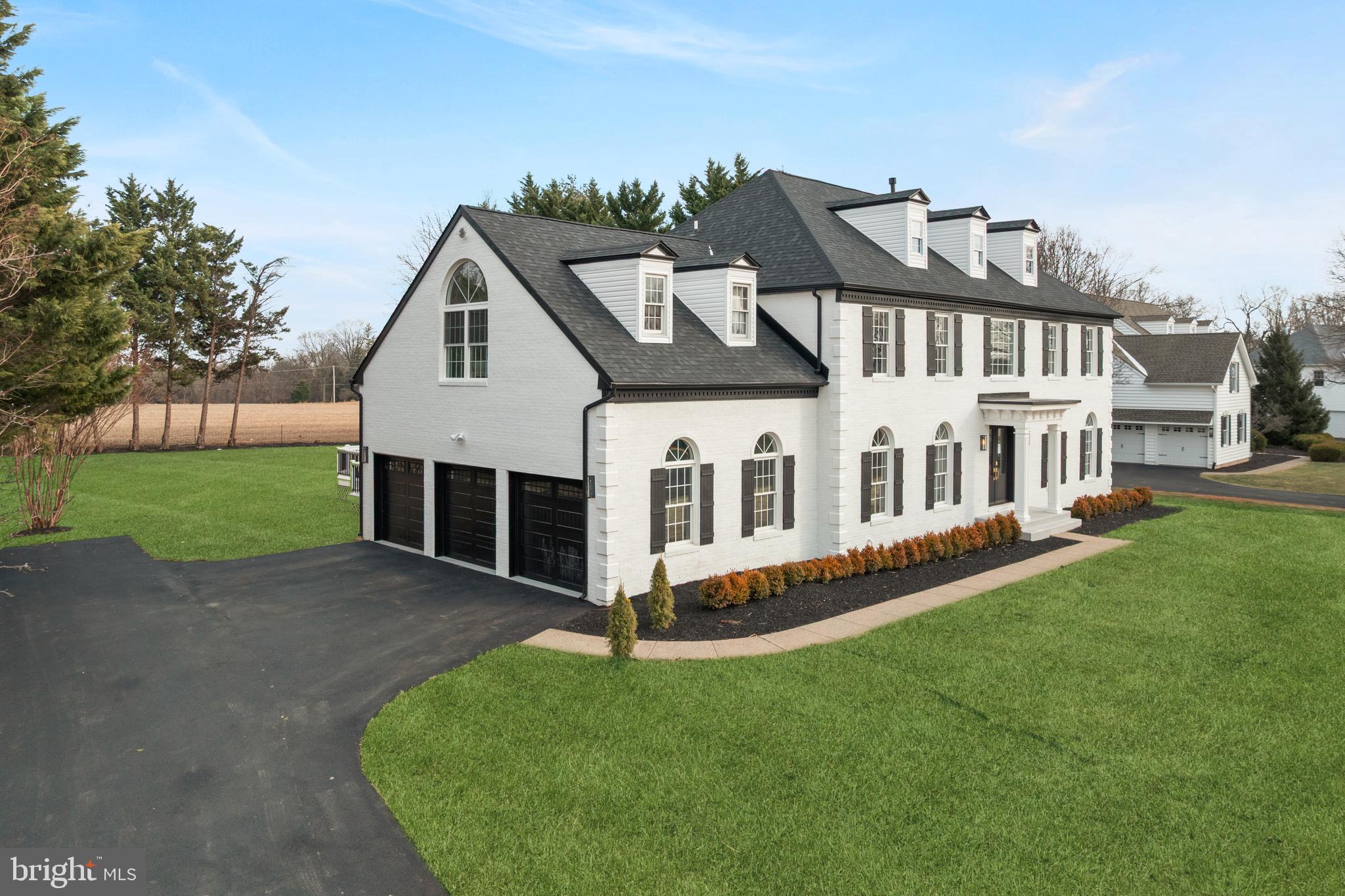 1586 Brookfield Road Newtown, PA 18940 - Photo 2 of 64 a front view of a house with a garden and yard