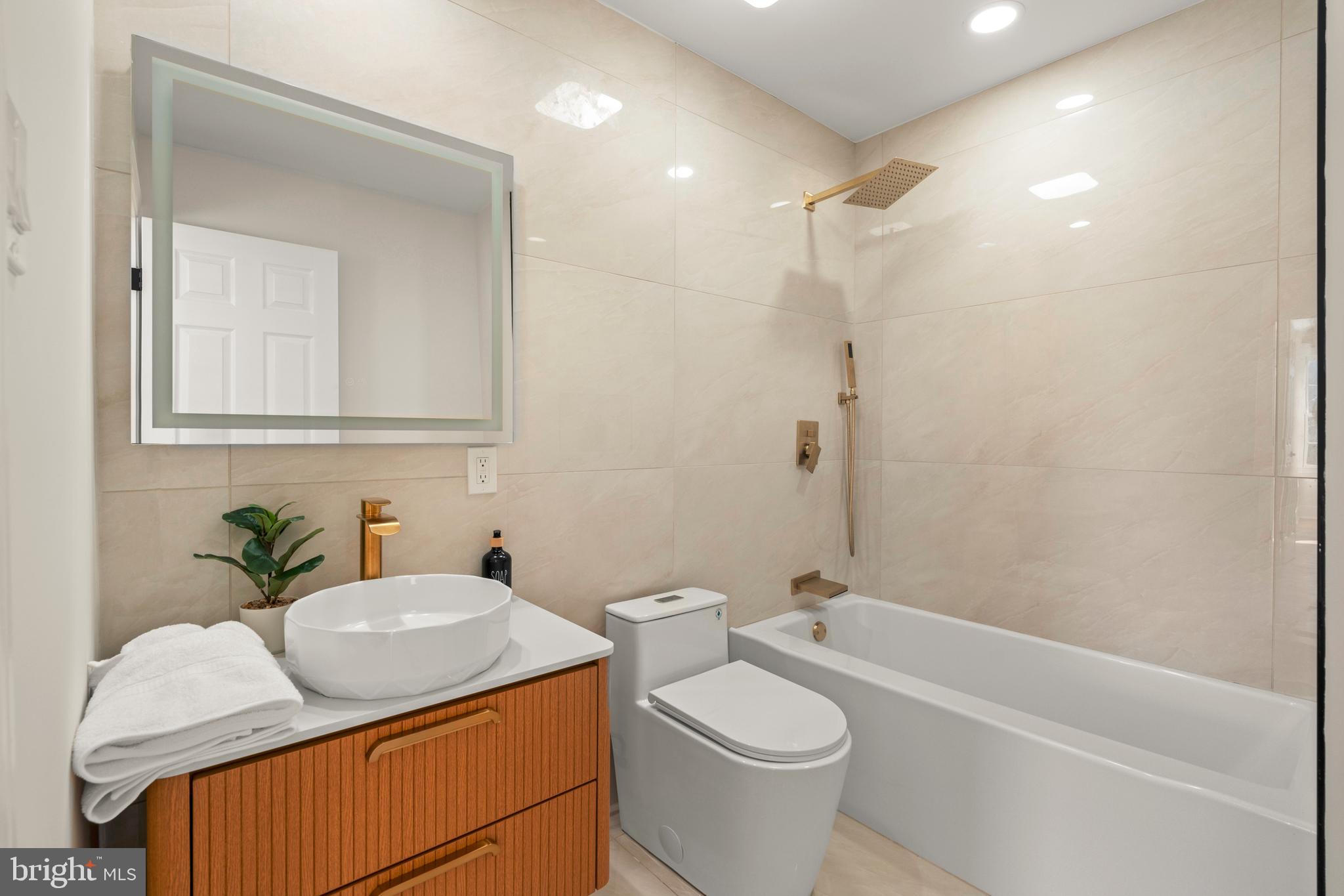 1586 Brookfield Road Newtown, PA 18940 - Photo 41 of 64 a bathroom with a granite countertop sink toilet and shower