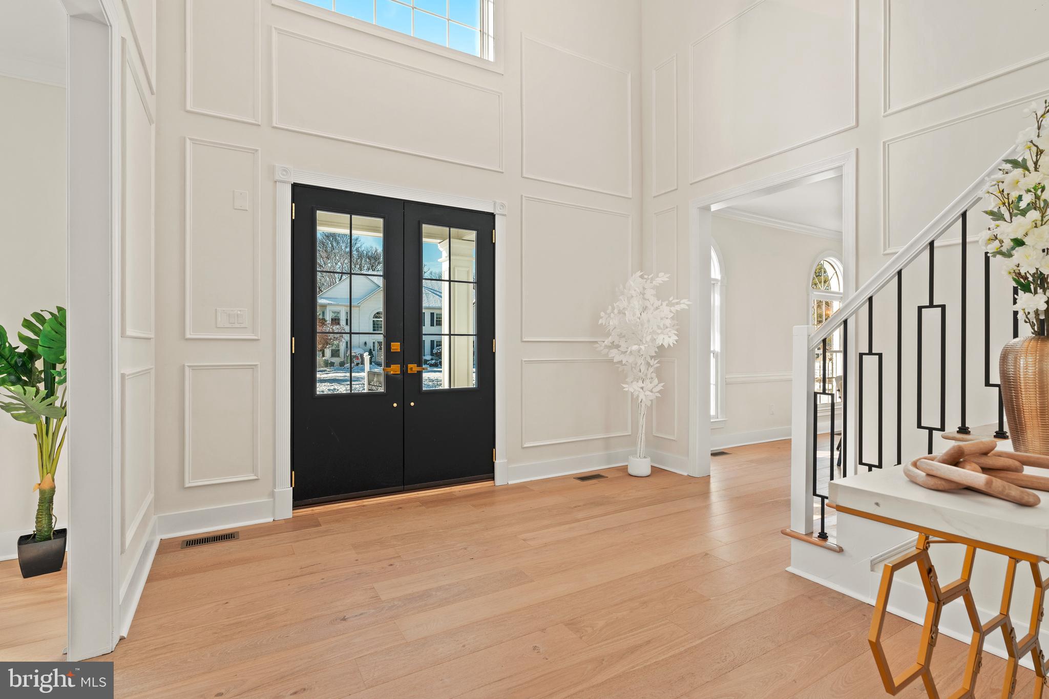 1586 Brookfield Road Newtown, PA 18940 - Photo 5 of 64 a view of a hallway with wooden floor and a bathroom