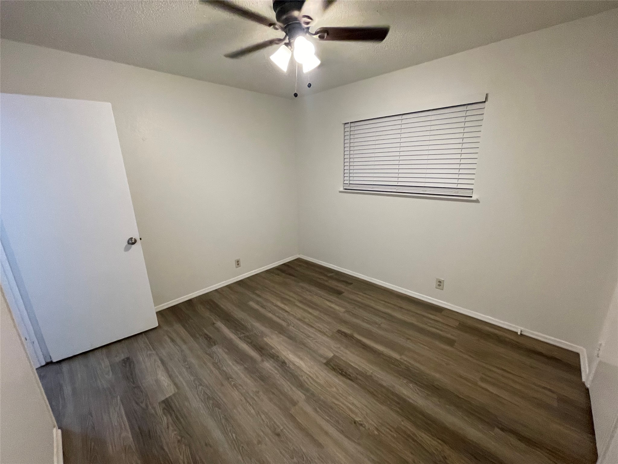 6206 Linda Lane, Unit A Austin, TX 78723 - Photo 16 of 19 an empty room with wooden floor fan and windows