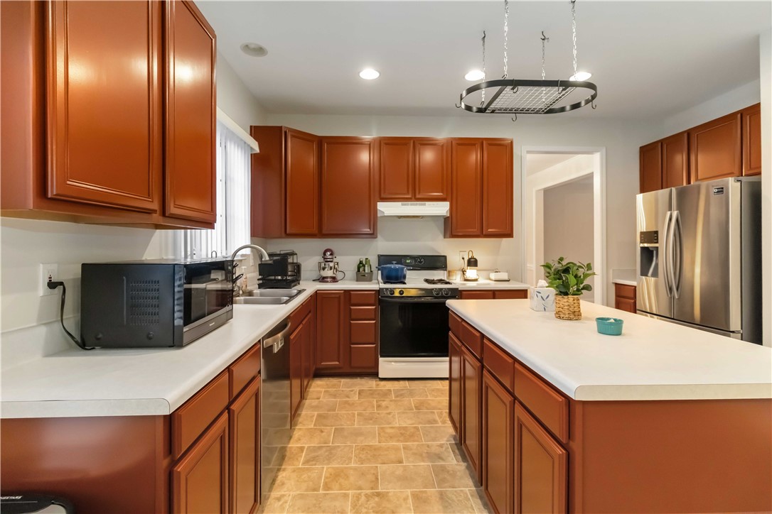 215 Ridge Bay Court Greenville, SC 29611 - Photo 11 of 35 This spacious kitchen offers ample cabinetry, modern appliances, and a convenient island for culinary endeavors.