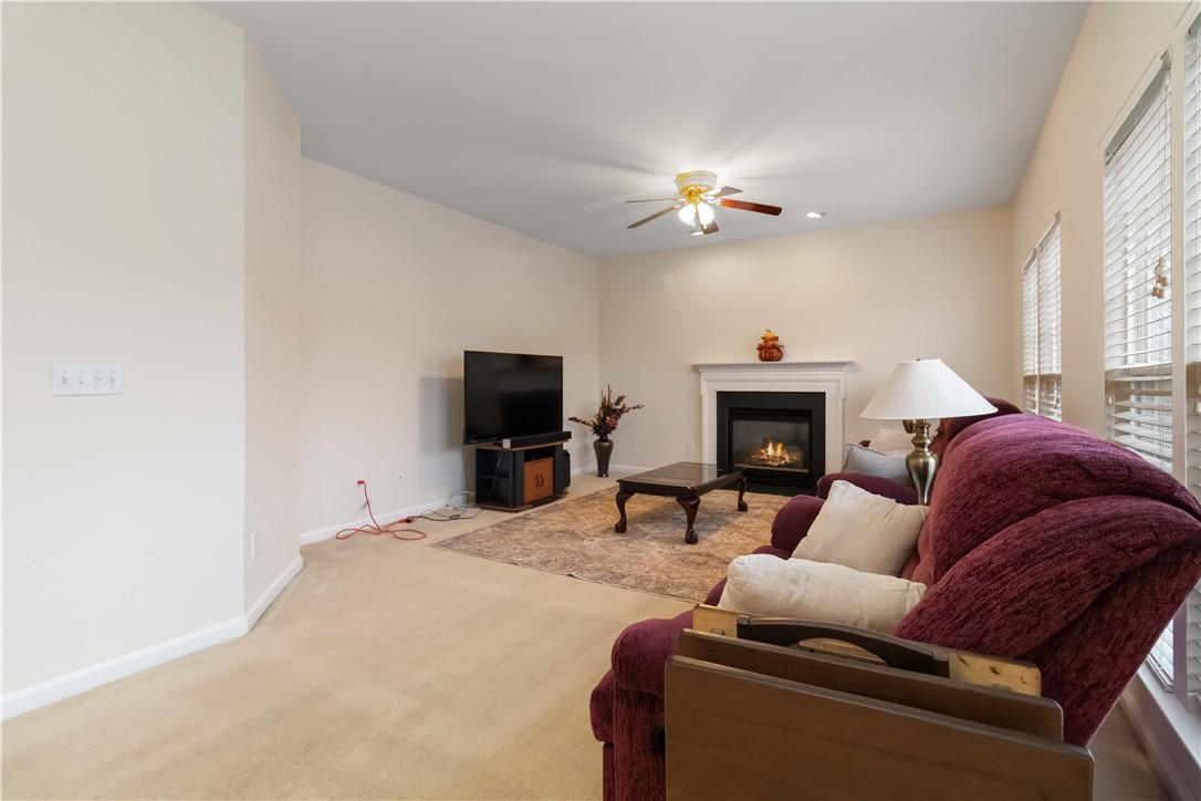 215 Ridge Bay Court Greenville, SC 29611 - Photo 14 of 35 This inviting living room features a cozy fireplace, creating an ideal setting for relaxation and gatherings.