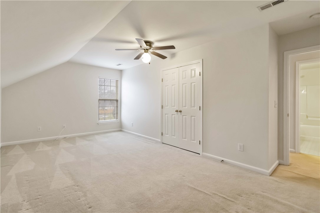 215 Ridge Bay Court Greenville, SC 29611 - Photo 21 of 35 This airy bedroom offers comfortable carpet and a convenient closet, perfect for tranquil living.