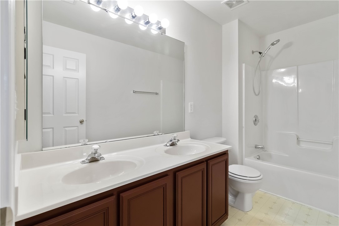 215 Ridge Bay Court Greenville, SC 29611 - Photo 23 of 35 This bright bathroom features a spacious dual-sink vanity and a comfortable shower-tub combination.